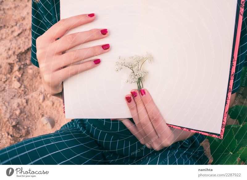 Woman's hands holding a book Elegant Design Nail polish Leisure and hobbies Reading Human being Feminine Adults 1 18 - 30 years Youth (Young adults) Art Artist