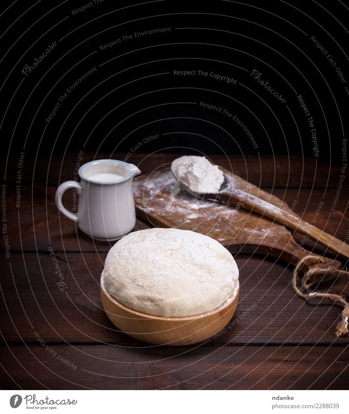 wheat yeast dough in a wooden bowl Food Dough Baked goods Bread Milk Bowl Spoon Table Kitchen Wood Eating Fresh Natural Above Brown White Yeast background