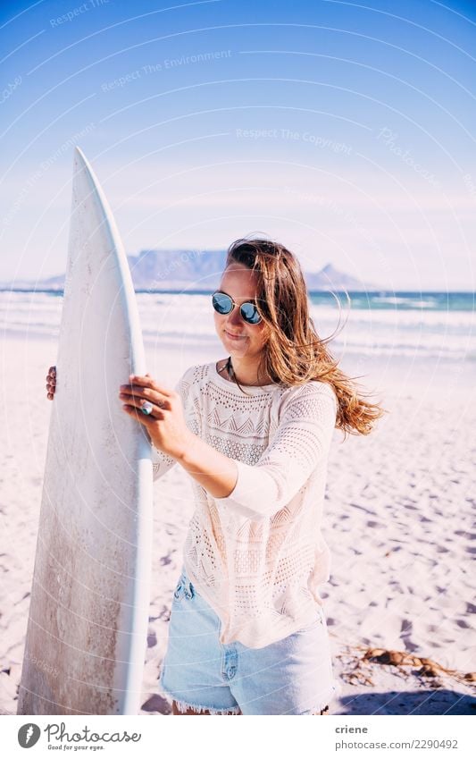Young female adult carrying surfboard on beach Lifestyle Happy Leisure and hobbies Summer Beach Ocean Woman Adults Smiling Surfboard Surfing outdoor recreation