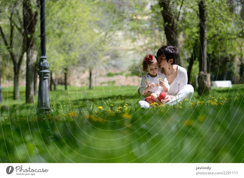 mother kissing her little daughter in urban park Lifestyle Joy Child Human being Feminine Baby Woman Adults Mother Family & Relations Couple Infancy 2