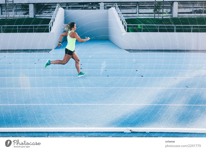 Female caucasian athlete running on blue running track Sports Fitness Speed Blue fast Running track Practice competiton Sportswear Colour photo Multicoloured