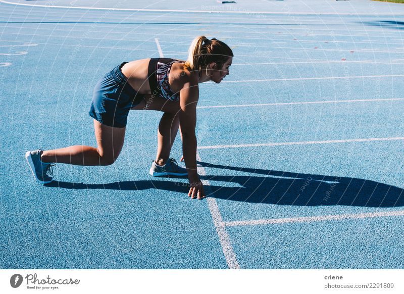 Fit female athlete sprinting on running track Sports Human being Feminine Woman Adults Fitness Speed Blue Beginning Practice Ready fast Finish line