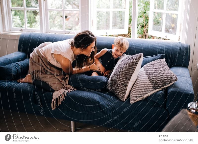 Happy Mother and toddler cuddling on couch at home Parenting Child Adults Family & Relations Infancy To enjoy Smiling Laughter Together Emotions Son Tickle Home