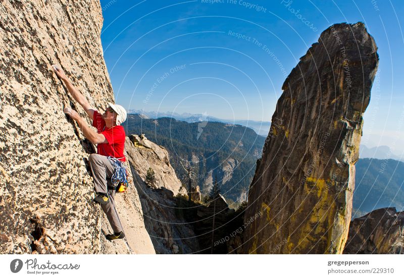 Male rock climber clinging to a steep cliff. 1 Human being 30 - 45 years Adults Athletic Bravery Self-confident Power Willpower Adventure Resolve Fitness