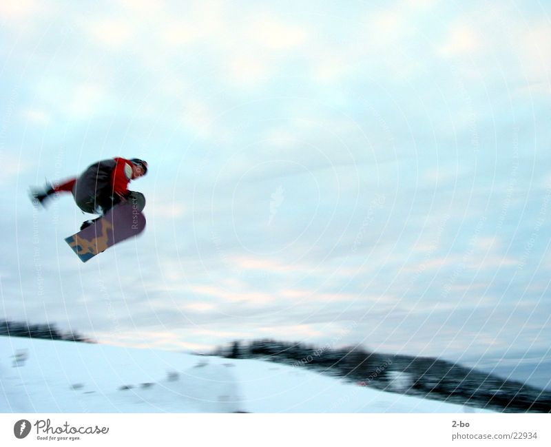 flying high Snowboard Jump Extreme sports Harz Motion blur Tall Brave Posture Snowboarder Snowboarding Flying Clouds in the sky 1 Exterior shot Colour photo