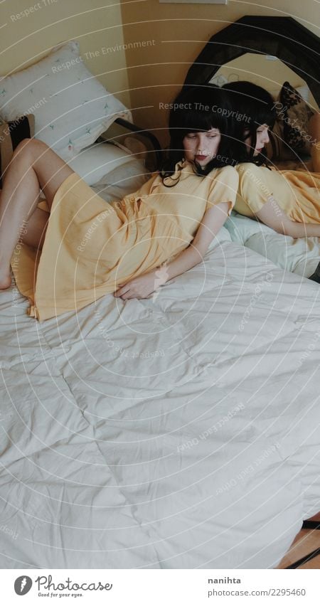 Young woman lying down in her bed Lifestyle Elegant Style Beautiful Relaxation Calm Living or residing Interior design Bed Bedroom Human being Feminine