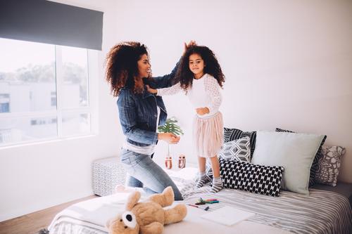 Young mom playing with little daughter Joy Happy Beautiful Playing House (Residential Structure) Bedroom Parenting Child Parents Adults Mother