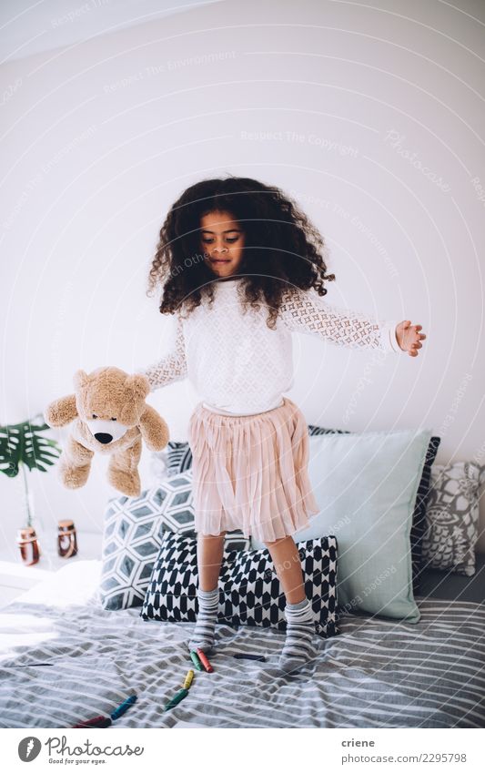 Little african girl jumping on bed with teddy bear Joy Happy Beautiful Playing Child Human being Infancy Toys Teddy bear Laughter Jump Happiness Small Cute