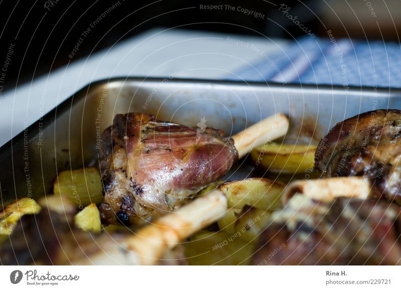 Knuckle of lamb with rosemary potatoes Meat Lunch Dinner To enjoy Delicious Appetite Lamb Potatoes Cooking Colour photo Interior shot Deserted