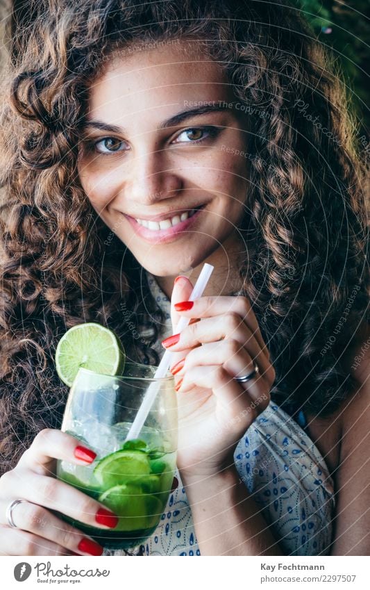 Smiling Brazilian woman with a glass of Caipirinha in her hand Beverage Alcoholic drinks Longdrink Cocktail Glass Lifestyle Elegant Style Exotic Happy Beautiful