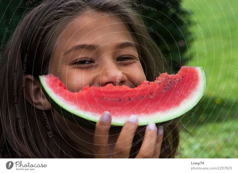 Smiling girl with a bitten melon in front of her mouth Joy Summer Garden Child Girl Infancy 1 Human being 8 - 13 years Brunette Eating Laughter Happiness Happy