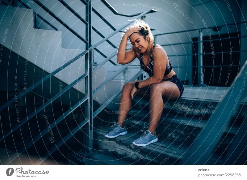 Happy exhausted athlete sitting and resting on stairs Lifestyle Sports Woman Adults Fitness Smiling Bright Modern Determination Fatigue Resting running after