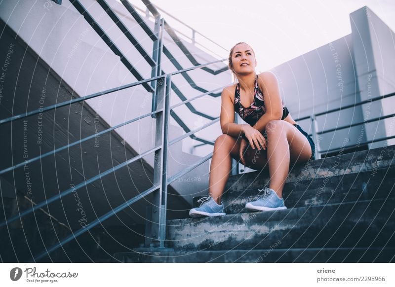 Female athlete having a break from working out Lifestyle Sports Woman Adults Fitness Bright Modern Determination Fatigue Resting running after Practice stairs