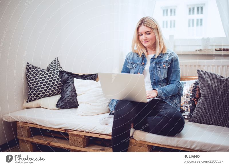 Young woman sitting on diy couch working with notebook Lifestyle Shopping Living or residing Flat (apartment) Interior design Room Living room Human being