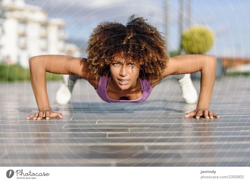 Black fit woman doing pushups on urban floor. Lifestyle Body Hair and hairstyles Leisure and hobbies Sports Human being Young woman Youth (Young adults) Woman