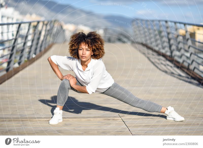 Young black woman doing stretching after running outdoors Lifestyle Beautiful Hair and hairstyles Wellness Leisure and hobbies Sports Jogging Human being