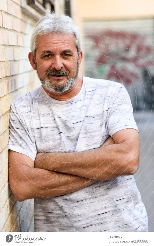 Mature man smiling at camera in urban background. Lifestyle Happy Human being Masculine Man Adults Male senior Hair and hairstyles 1 45 - 60 years Street