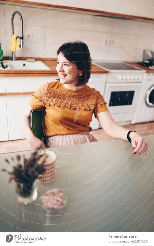 Young woman sitting in her kitchen Feminine Youth (Young adults) Woman Adults 1 Human being 18 - 30 years Living or residing Contentment Kitchen Kitchen Table