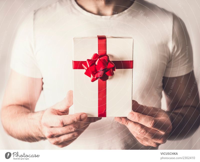 Gift box with red ribbon in the hands Style Design Joy Beautiful Event Valentine's Day Christmas & Advent Human being Masculine Hand Decoration Moody Love Man