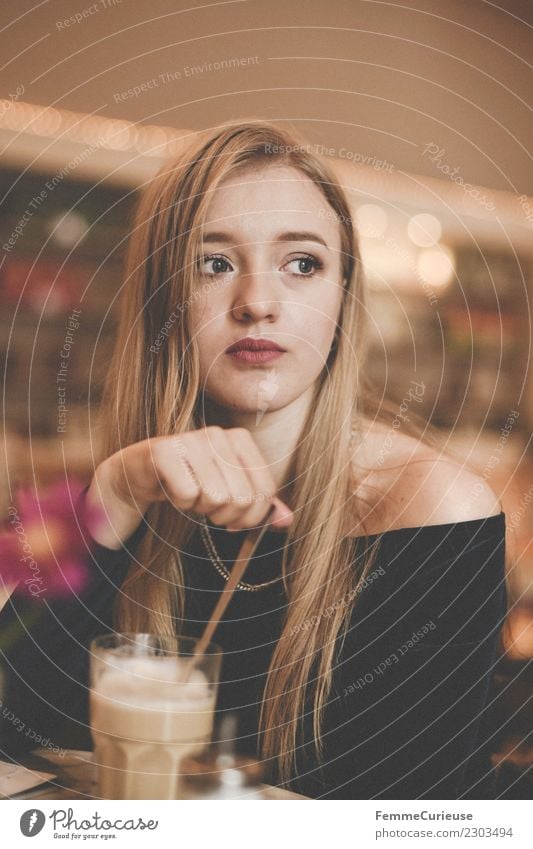 Young woman having a coffee in a café Lifestyle Feminine Youth (Young adults) Woman Adults 1 Human being 18 - 30 years Leisure and hobbies To enjoy Café Wait