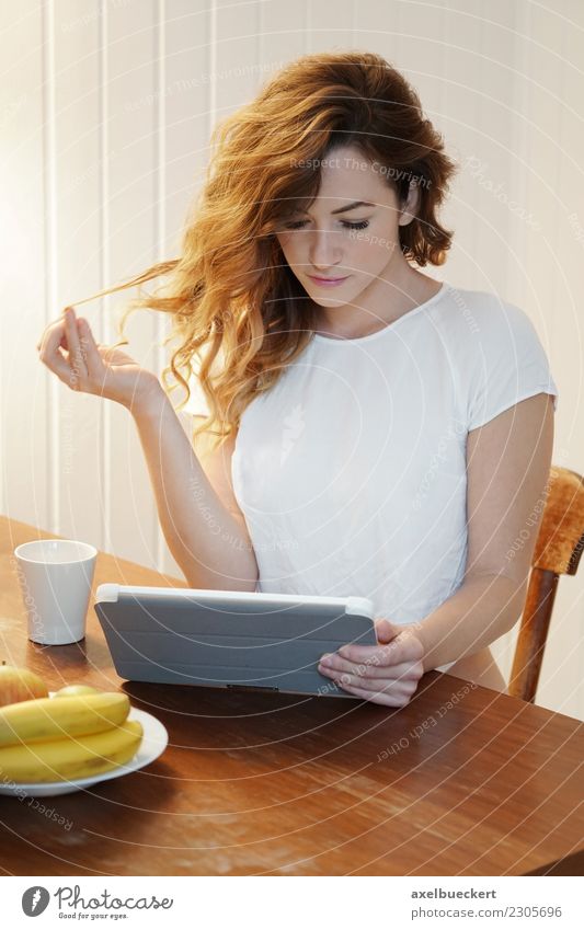 young woman using tablet computer at breakfast table Fruit Coffee Lifestyle Relaxation Leisure and hobbies Living or residing Flat (apartment) Table Kitchen