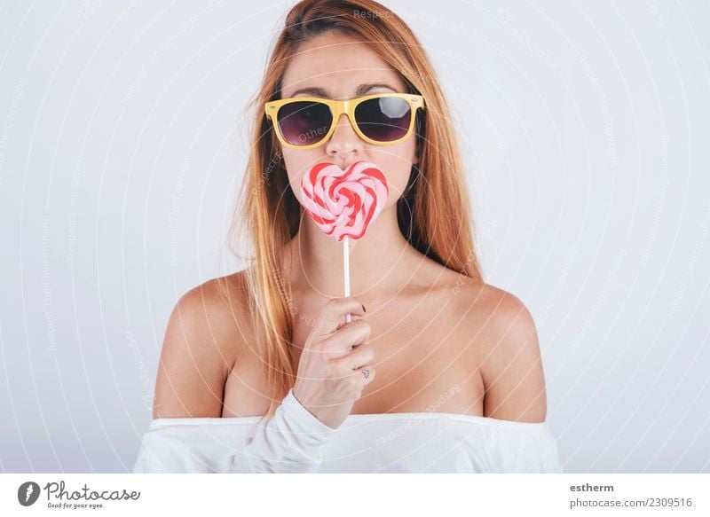 Portrait of young woman with heart shaped lollipop Candy Lifestyle Style Joy Wellness Valentine's Day Human being Feminine Young woman Youth (Young adults)
