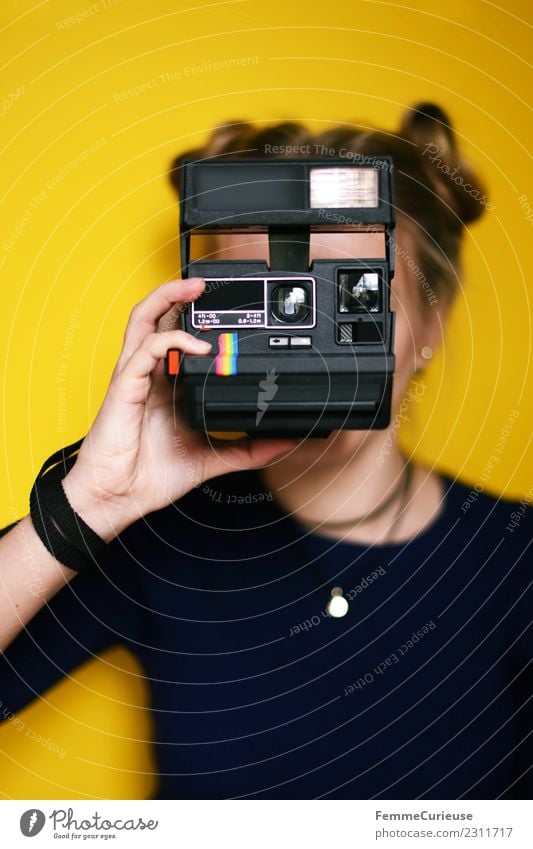 Young woman holding an instant camera in front of her face Lifestyle Feminine Youth (Young adults) Woman Adults 1 Human being 18 - 30 years Leisure and hobbies