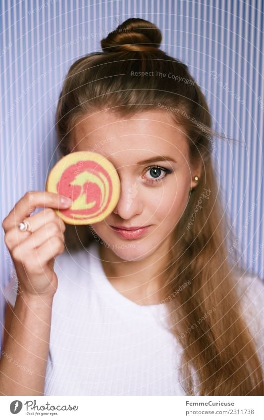 Young woman holding a cookie in front of her face Feminine Youth (Young adults) Woman Adults 1 Human being 18 - 30 years To enjoy Cookie Butter cookie