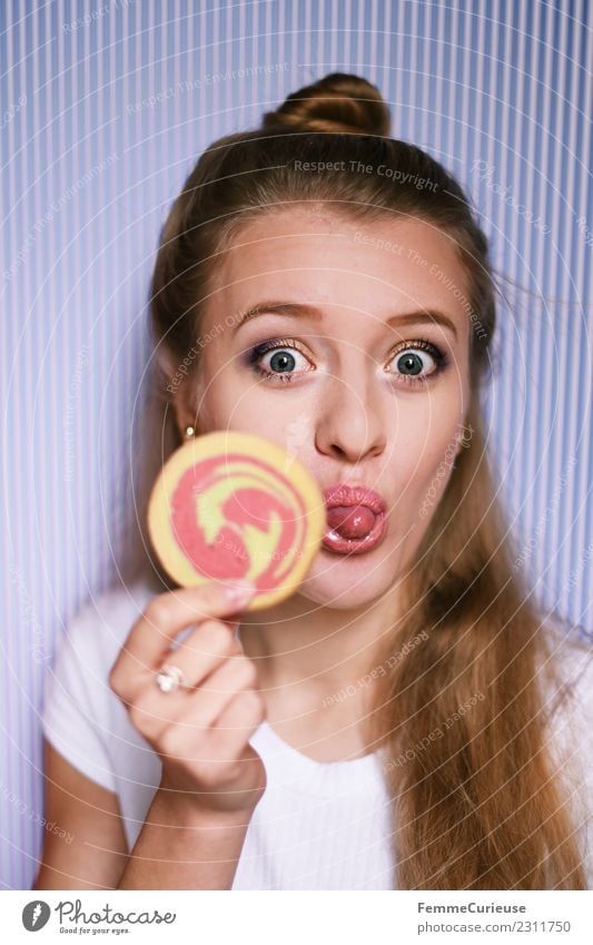 Young blonde woman showing a cookie Feminine Young woman Youth (Young adults) Woman Adults 1 Human being 18 - 30 years Joy Stick out Tongue Cookie Butter cookie