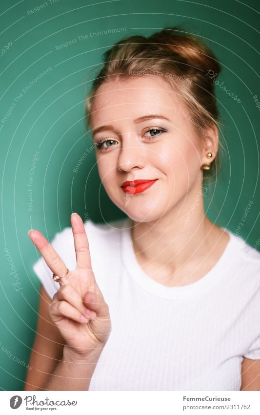 Young blonde woman showing the peace sign Young woman Youth (Young adults) Woman Adults 1 Human being 18 - 30 years Beautiful Peace Sign Fingers Hand Chignon