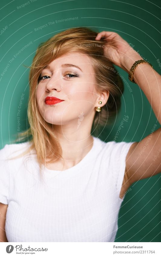 Young blonde woman posing in front of turquoise background Elegant Style Feminine Young woman Youth (Young adults) Woman Adults 1 Human being 18 - 30 years