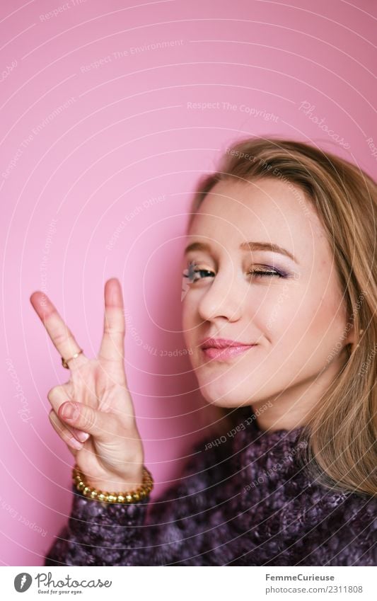 Young blonde woman showing the peace sign Feminine Young woman Youth (Young adults) Woman Adults 1 Human being 18 - 30 years Peace Beautiful Hand Gesture Wink