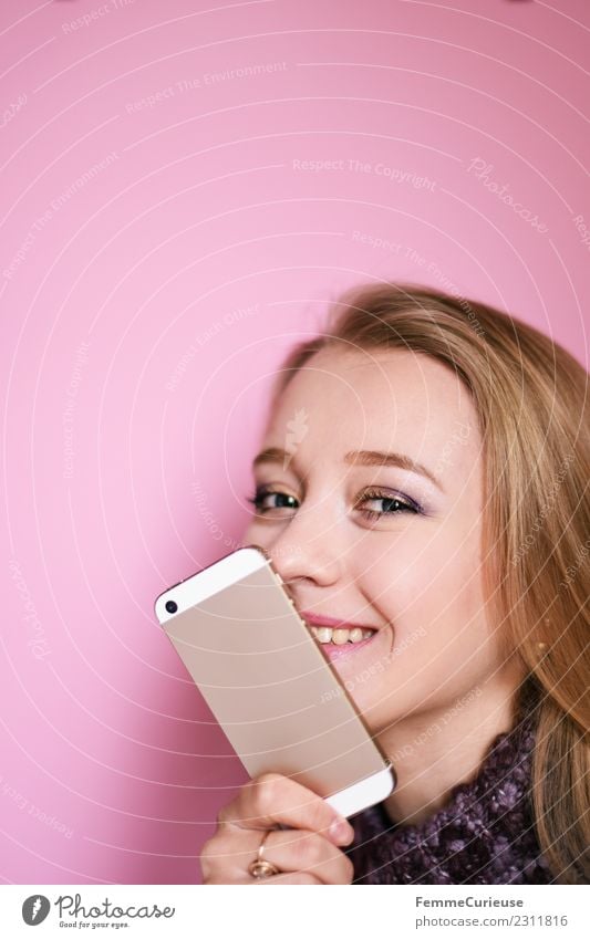 Young blonde girl with her mobile phone Lifestyle Feminine Young woman Youth (Young adults) Woman Adults 1 Human being 18 - 30 years Communicate