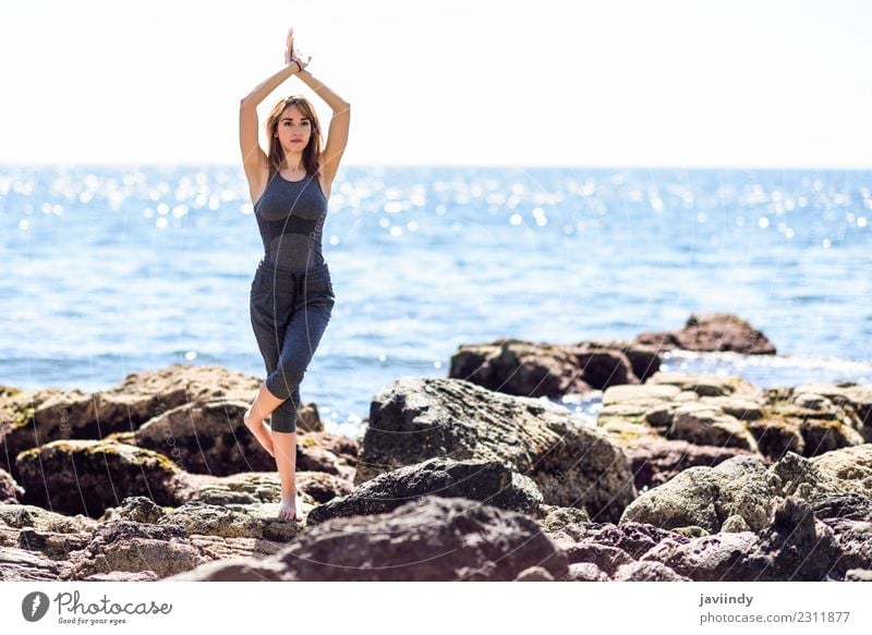 Young woman doing yoga in the beach. Lifestyle Wellness Relaxation Meditation Beach Sports Yoga Human being Youth (Young adults) Woman Adults 1 18 - 30 years