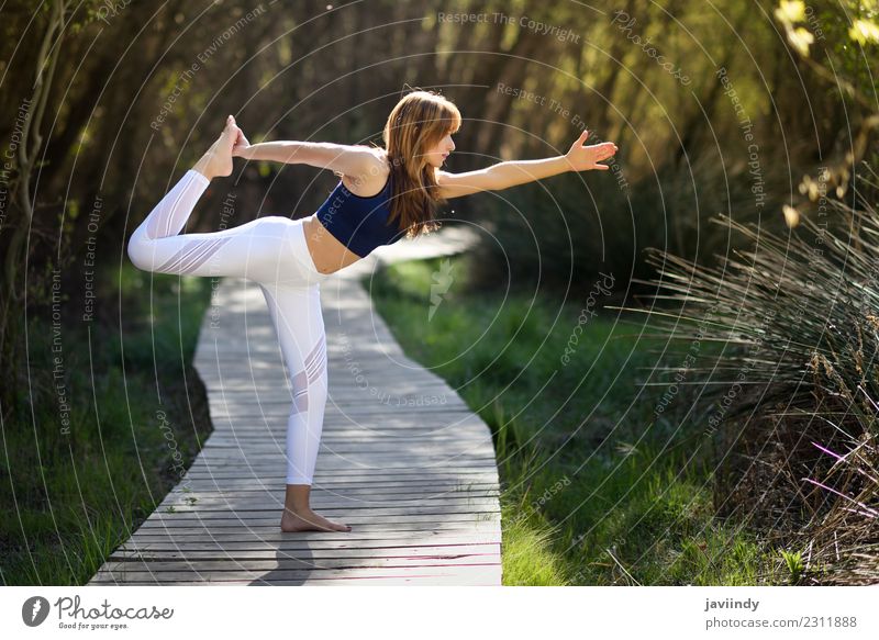 Young woman doing yoga in nature - a Royalty Free Stock Photo from Photocase