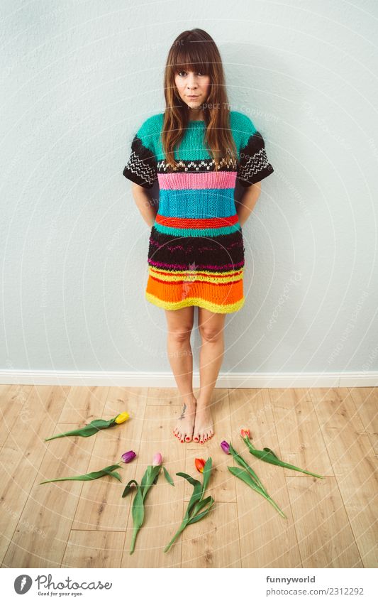 Woman in a wool dress surrounded by tulips Human being Feminine Adults 1 Brunette Bangs Looking Stand Funny Natural Center point Arrangement Whimsical Joy Tulip