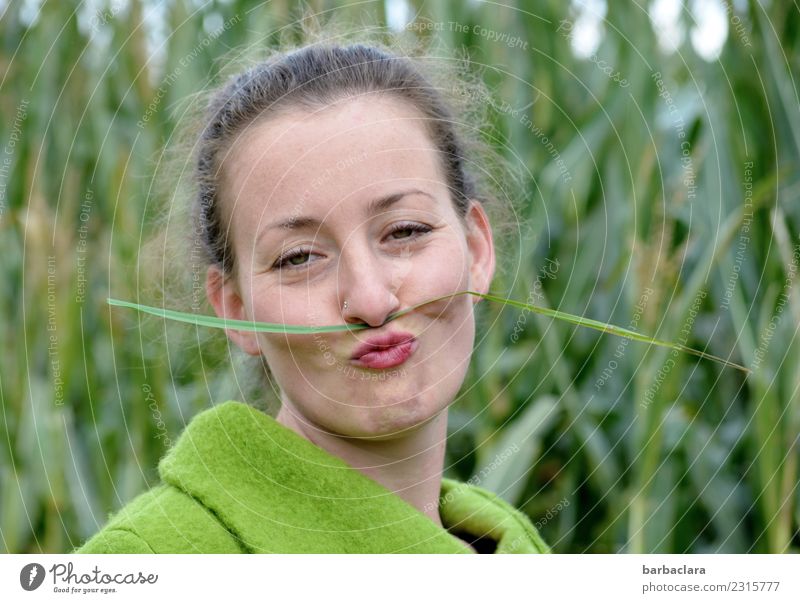 Curious | young woman with grass green moustache Feminine Woman Adults 1 Human being Nature Plant Autumn Climate Grass Maize field Field Jacket Moustache Curl