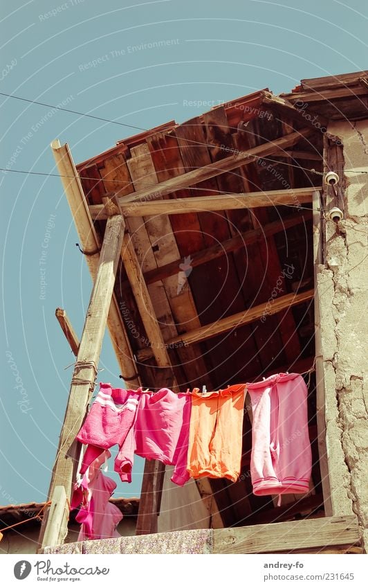 Drying laundry Village Ruin Wall (barrier) Wall (building) Balcony Terrace Roof Clothing Pants Hang Poverty Small Above Clean Multicoloured Pink Infancy Life