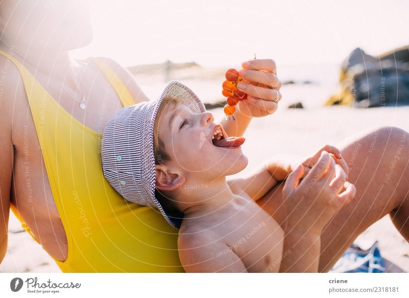 Cute happy little boy eating grapes at the beach Fruit Eating Lifestyle Joy Happy Leisure and hobbies Playing Vacation & Travel Summer Sun Beach Ocean Child