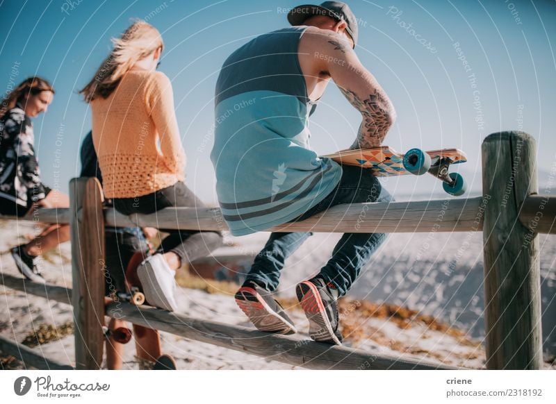 Group of friends hanging out with skateboards at beach Joy Life Leisure and hobbies Summer Beach Human being Woman Adults Man Friendship Culture Cool (slang)