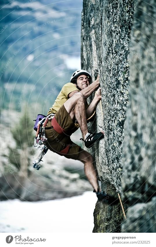 Rock climber clinging to a cliff. Adventure Mountain Sports Climbing Mountaineering Success Rope Man Adults 1 Human being 18 - 30 years Youth (Young adults)