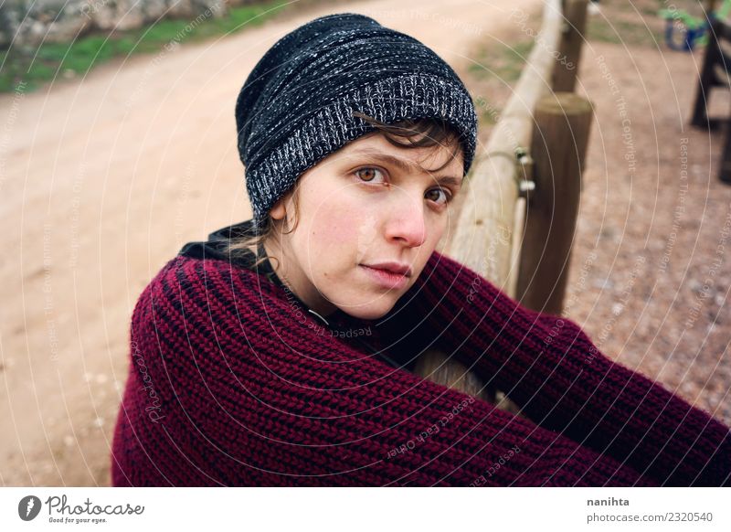 Young sad woman otudoors Lifestyle Style Human being Feminine Young woman Youth (Young adults) 1 18 - 30 years Adults Nature Park Sweater Hat Brunette Wood Wait