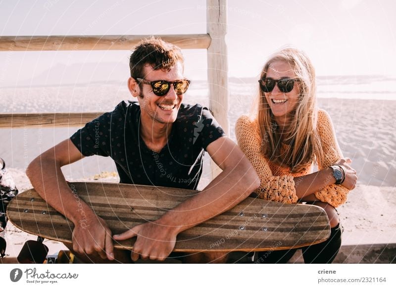 Happy caucasian couple with longboard smiling Lifestyle Joy Leisure and hobbies Vacation & Travel Summer Sunbathing Beach Ocean Woman Adults Friendship Couple