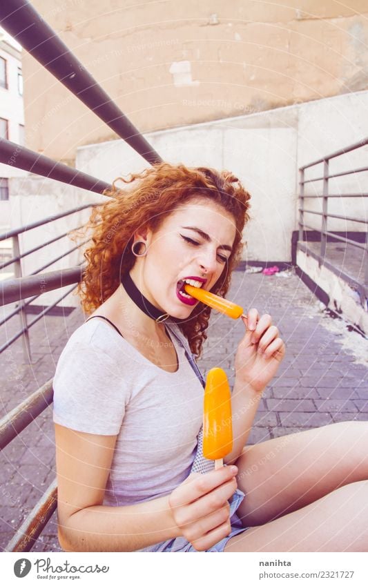 Young redhead woman eating orange ice creams Food Ice cream Eating Lifestyle Style Joy Vacation & Travel Summer Summer vacation Human being Feminine Young woman