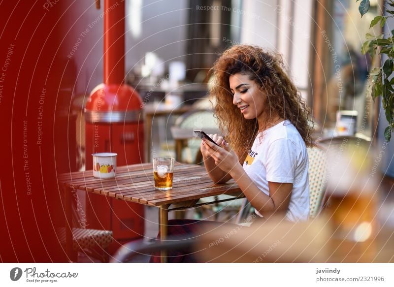 Girl sitting in a street bar looking at her smartphone Beverage Lifestyle Style Happy Beautiful Hair and hairstyles Leisure and hobbies Restaurant Telephone PDA