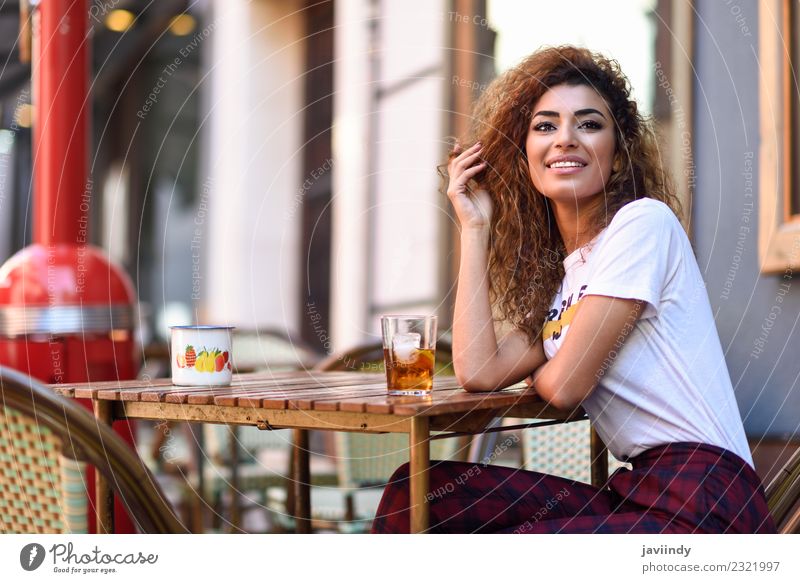 Young woman smiling and sitting in an urban bar Beverage Lifestyle Style Happy Beautiful Hair and hairstyles Leisure and hobbies Restaurant Human being Woman