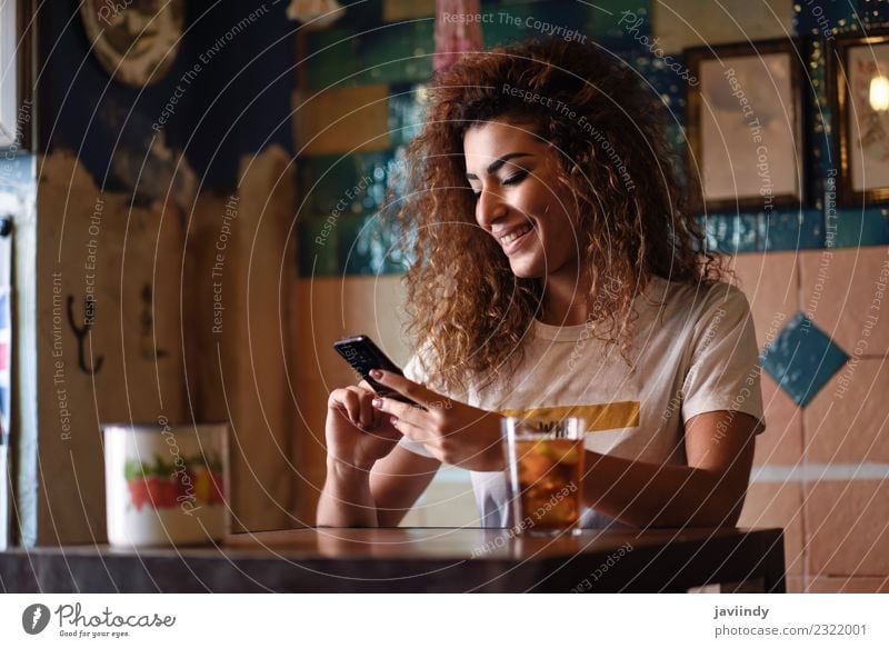 Woman in a beautiful bar looking at her smartphone Beverage Drinking Lifestyle Style Joy Happy Beautiful Hair and hairstyles Leisure and hobbies Restaurant