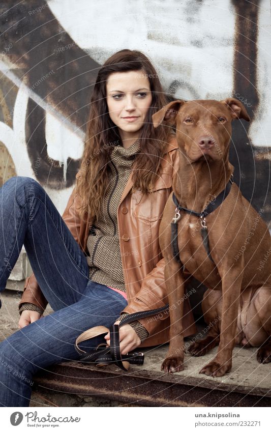 Woman with dog Young woman Youth (Young adults) Adults 1 Human being 18 - 30 years Jeans Jacket Brunette Long-haired Animal Pet Dog Observe To hold on Sit Wait