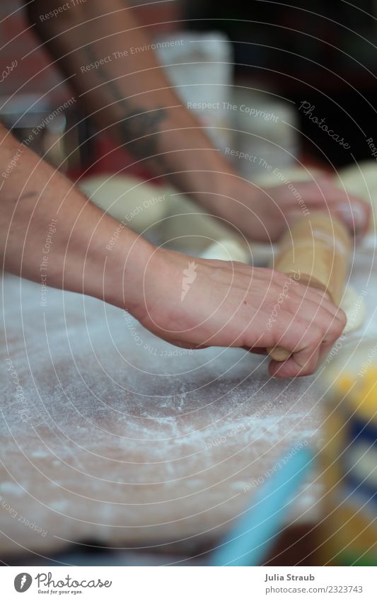 rolling out dough rolling pin pizza Arm Hand Tattoo Movement Fresh Authentic Diligent Dough Roll out Pizza Baker Flour Colour photo Exterior shot