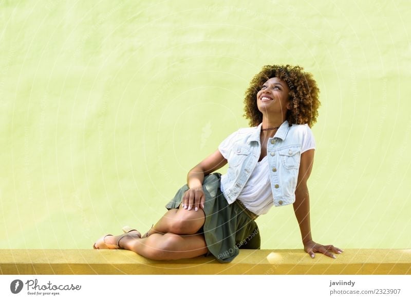Young black woman, afro hairstyle, sitting on a wall smiling Lifestyle Style Happy Beautiful Hair and hairstyles Face Human being Feminine Young woman